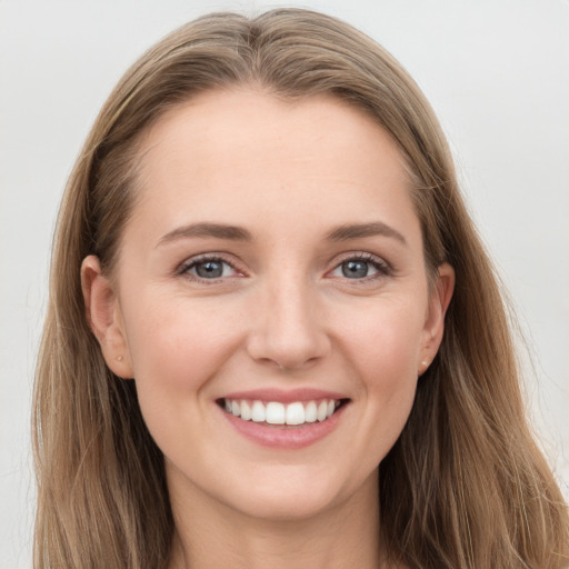 Joyful white young-adult female with long  brown hair and grey eyes