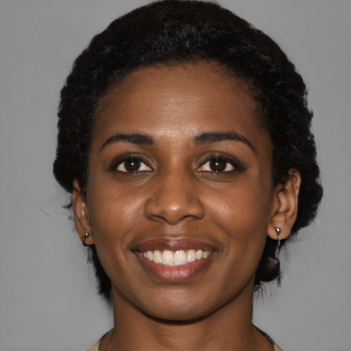 Joyful black young-adult female with medium  black hair and brown eyes