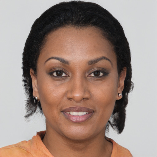 Joyful black young-adult female with medium  brown hair and brown eyes
