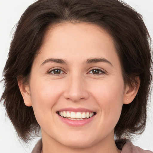 Joyful white young-adult female with medium  brown hair and brown eyes