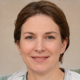 Joyful white adult female with medium  brown hair and grey eyes