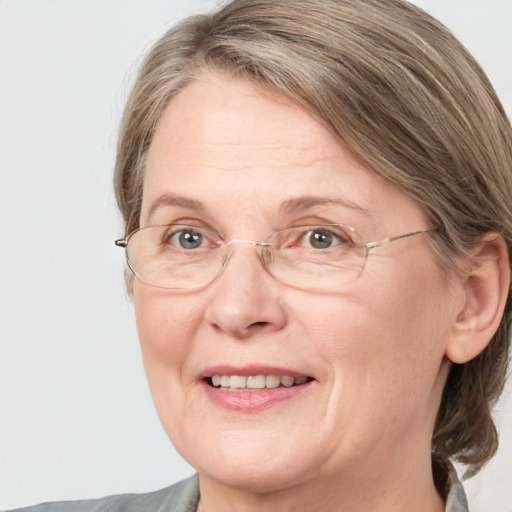 Joyful white middle-aged female with medium  brown hair and blue eyes