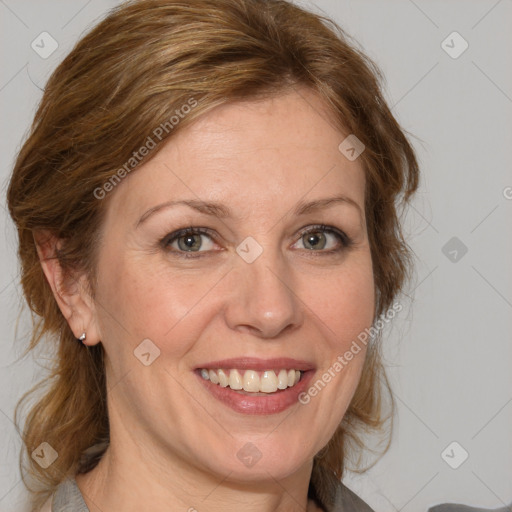 Joyful white adult female with medium  brown hair and blue eyes