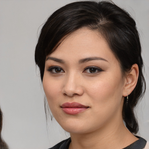 Joyful white young-adult female with medium  black hair and brown eyes