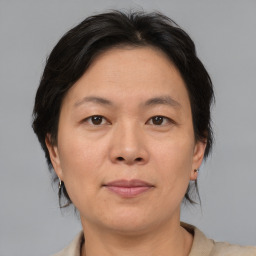 Joyful asian adult female with medium  brown hair and brown eyes