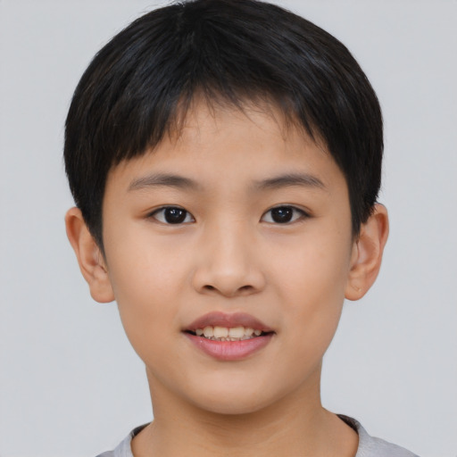 Joyful asian child male with short  brown hair and brown eyes