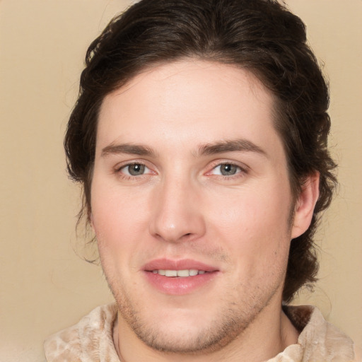 Joyful white young-adult male with medium  brown hair and brown eyes