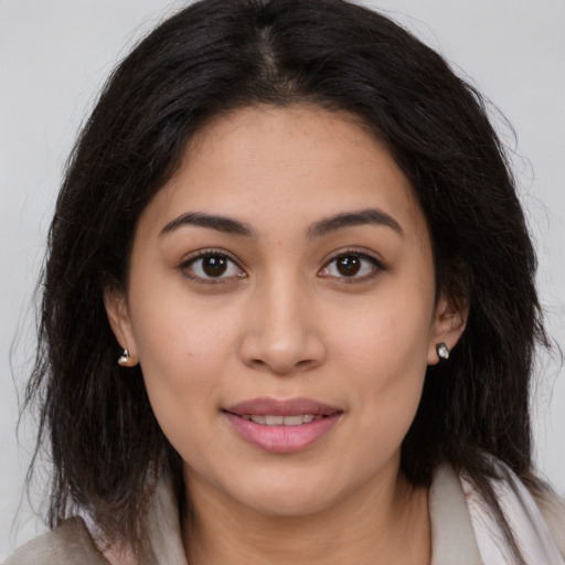 Joyful latino young-adult female with medium  brown hair and brown eyes