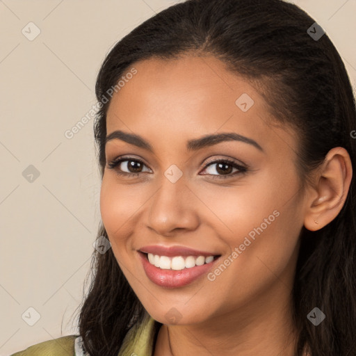 Joyful latino young-adult female with long  brown hair and brown eyes