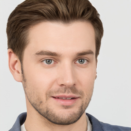 Joyful white young-adult male with short  brown hair and grey eyes