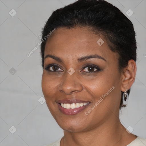 Joyful black young-adult female with short  brown hair and brown eyes