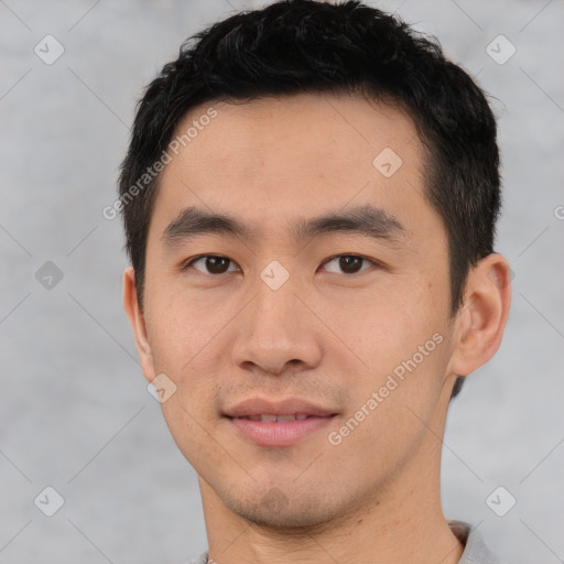 Joyful asian young-adult male with short  black hair and brown eyes