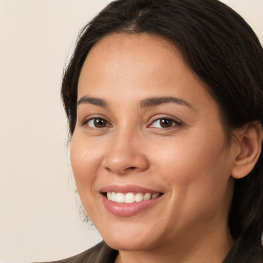 Joyful white young-adult female with long  brown hair and brown eyes