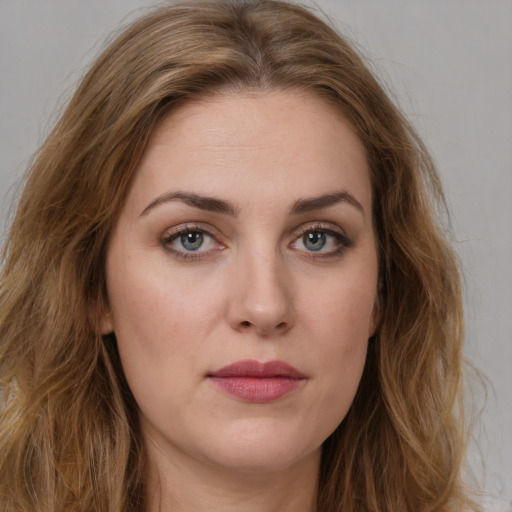 Joyful white young-adult female with long  brown hair and green eyes