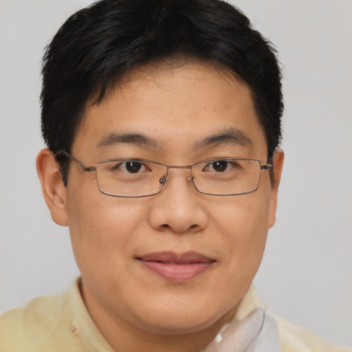 Joyful asian adult male with short  brown hair and brown eyes