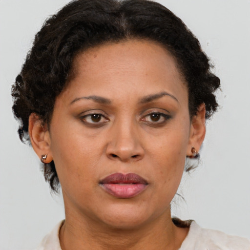 Joyful latino adult female with short  brown hair and brown eyes