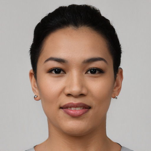 Joyful latino young-adult female with short  black hair and brown eyes