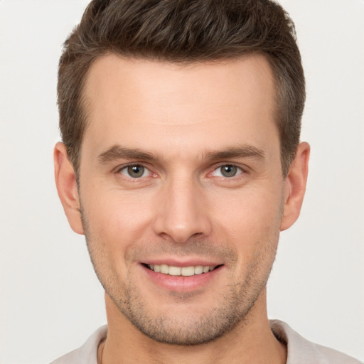 Joyful white young-adult male with short  brown hair and brown eyes