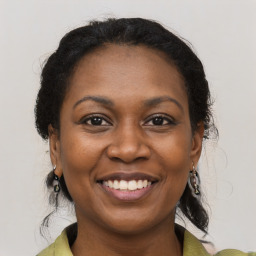 Joyful black adult female with medium  brown hair and brown eyes