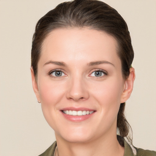 Joyful white young-adult female with long  brown hair and grey eyes