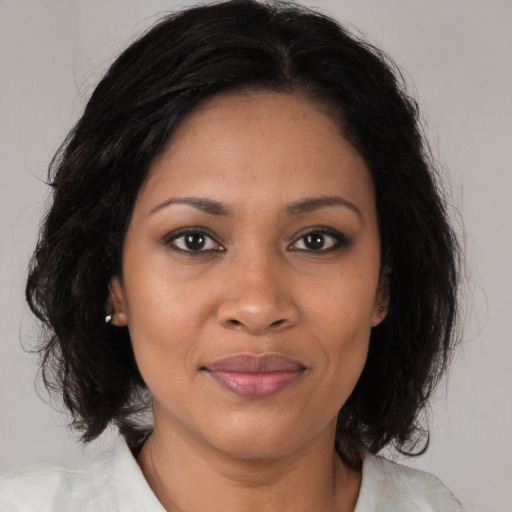 Joyful black young-adult female with medium  brown hair and brown eyes