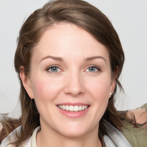 Joyful white young-adult female with medium  brown hair and blue eyes