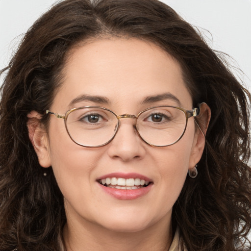 Joyful white adult female with long  brown hair and brown eyes