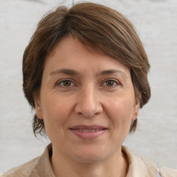 Joyful white adult female with medium  brown hair and brown eyes