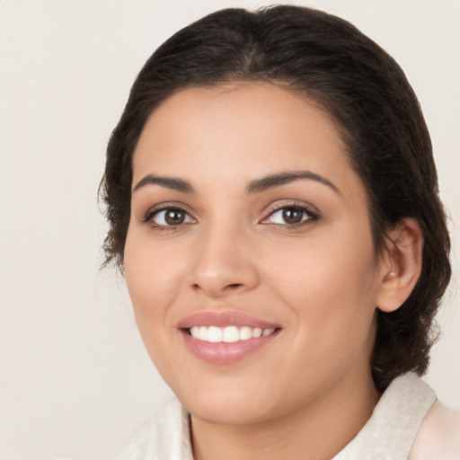 Joyful latino young-adult female with medium  brown hair and brown eyes