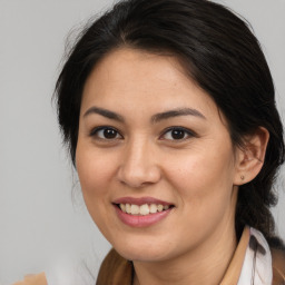 Joyful latino young-adult female with medium  brown hair and brown eyes