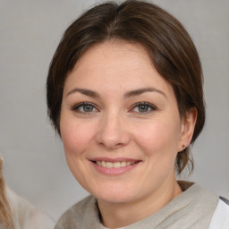 Joyful white adult female with medium  brown hair and brown eyes