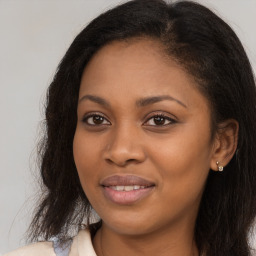 Joyful black young-adult female with long  brown hair and brown eyes