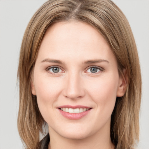 Joyful white young-adult female with long  brown hair and grey eyes