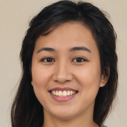 Joyful asian young-adult female with long  brown hair and brown eyes