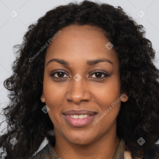 Joyful black young-adult female with long  black hair and brown eyes