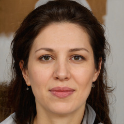 Joyful white adult female with medium  brown hair and brown eyes