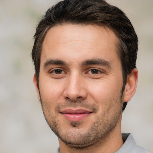 Joyful white young-adult male with short  brown hair and brown eyes