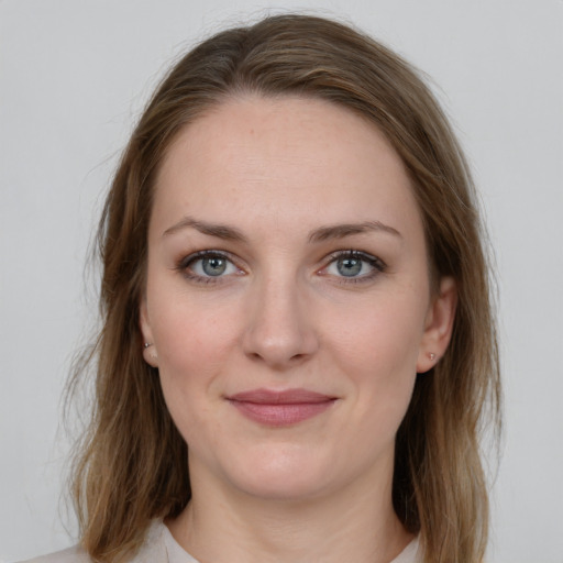 Joyful white young-adult female with medium  brown hair and green eyes