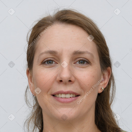 Joyful white adult female with long  brown hair and grey eyes