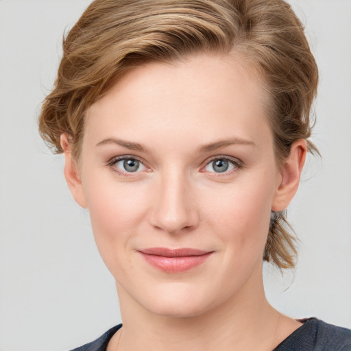 Joyful white young-adult female with medium  brown hair and blue eyes