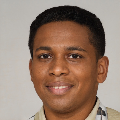 Joyful latino young-adult male with short  black hair and brown eyes