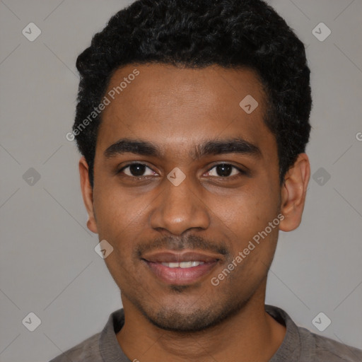 Joyful black young-adult male with short  black hair and brown eyes