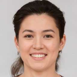 Joyful white young-adult female with medium  brown hair and brown eyes