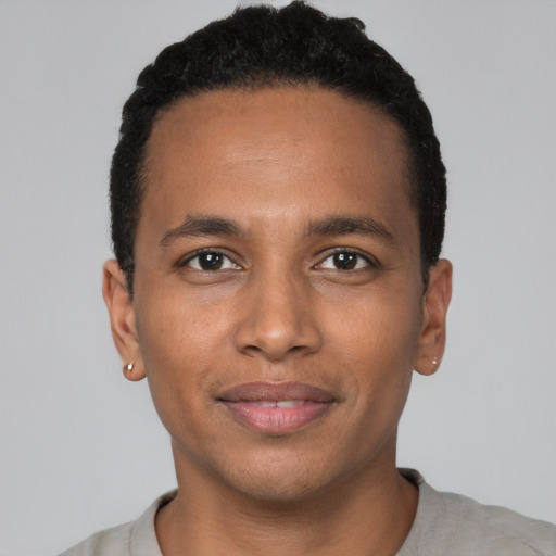 Joyful black young-adult male with short  brown hair and brown eyes