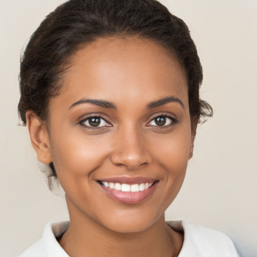 Joyful white young-adult female with short  brown hair and brown eyes