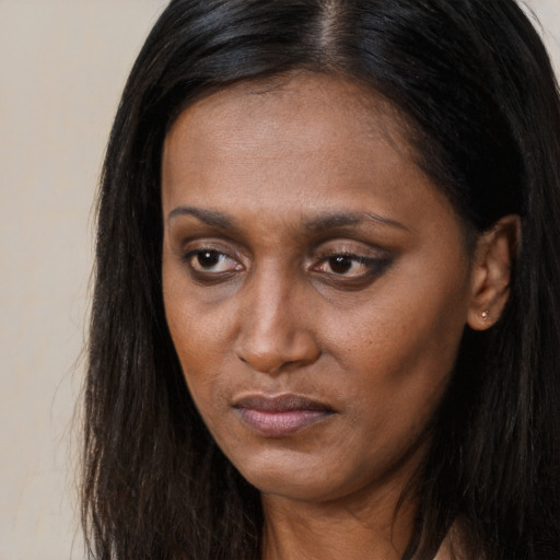 Neutral asian adult female with long  brown hair and brown eyes