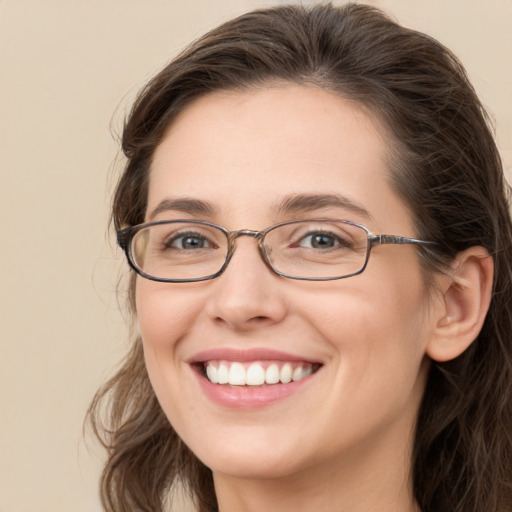 Joyful white young-adult female with long  brown hair and green eyes