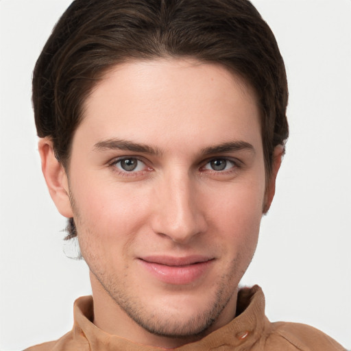 Joyful white young-adult male with short  brown hair and grey eyes