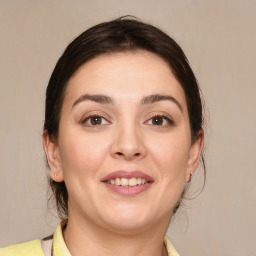 Joyful white young-adult female with medium  brown hair and brown eyes