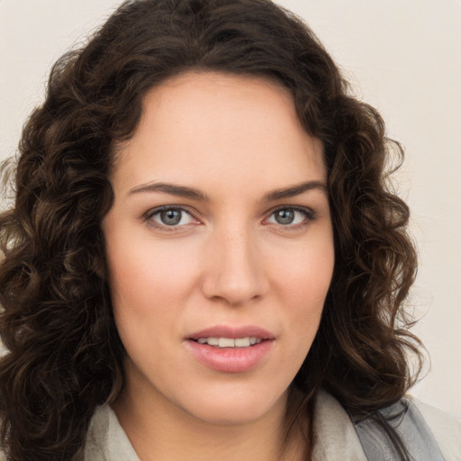 Joyful white young-adult female with long  brown hair and green eyes